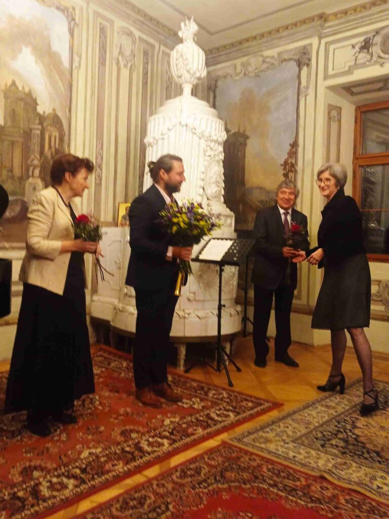 a man and woman standing in front of a painting